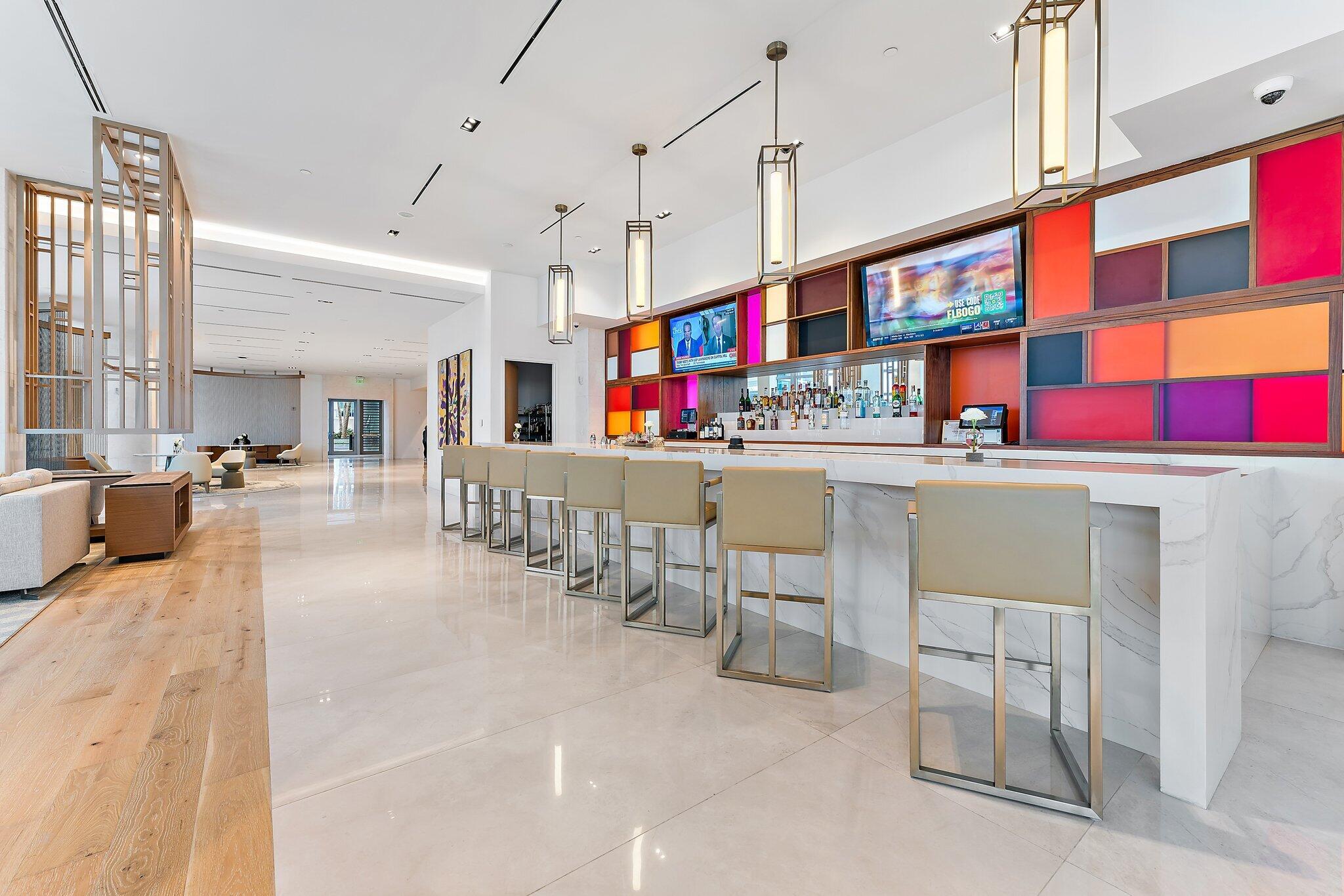 3100 North Ocean Drive, Unit H1206 Singer Island, FL 33404 - Photo 41 of 78 a room with lots of white furniture and a chandelier