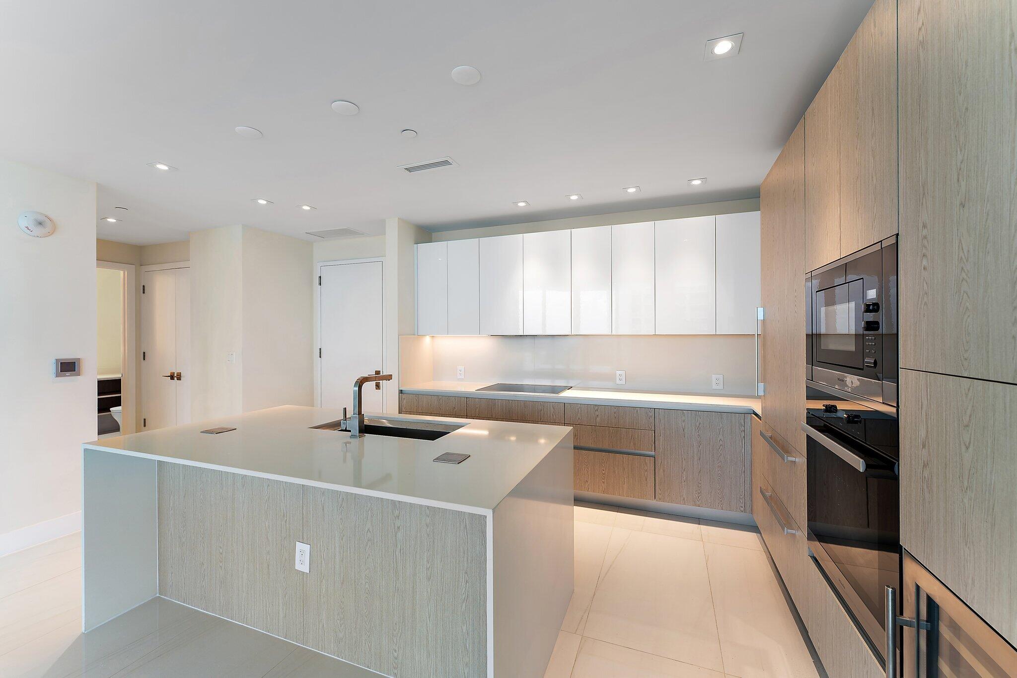 3100 North Ocean Drive, Unit H1206 Singer Island, FL 33404 - Photo 5 of 78 a kitchen with kitchen island a sink stainless steel appliances and cabinets