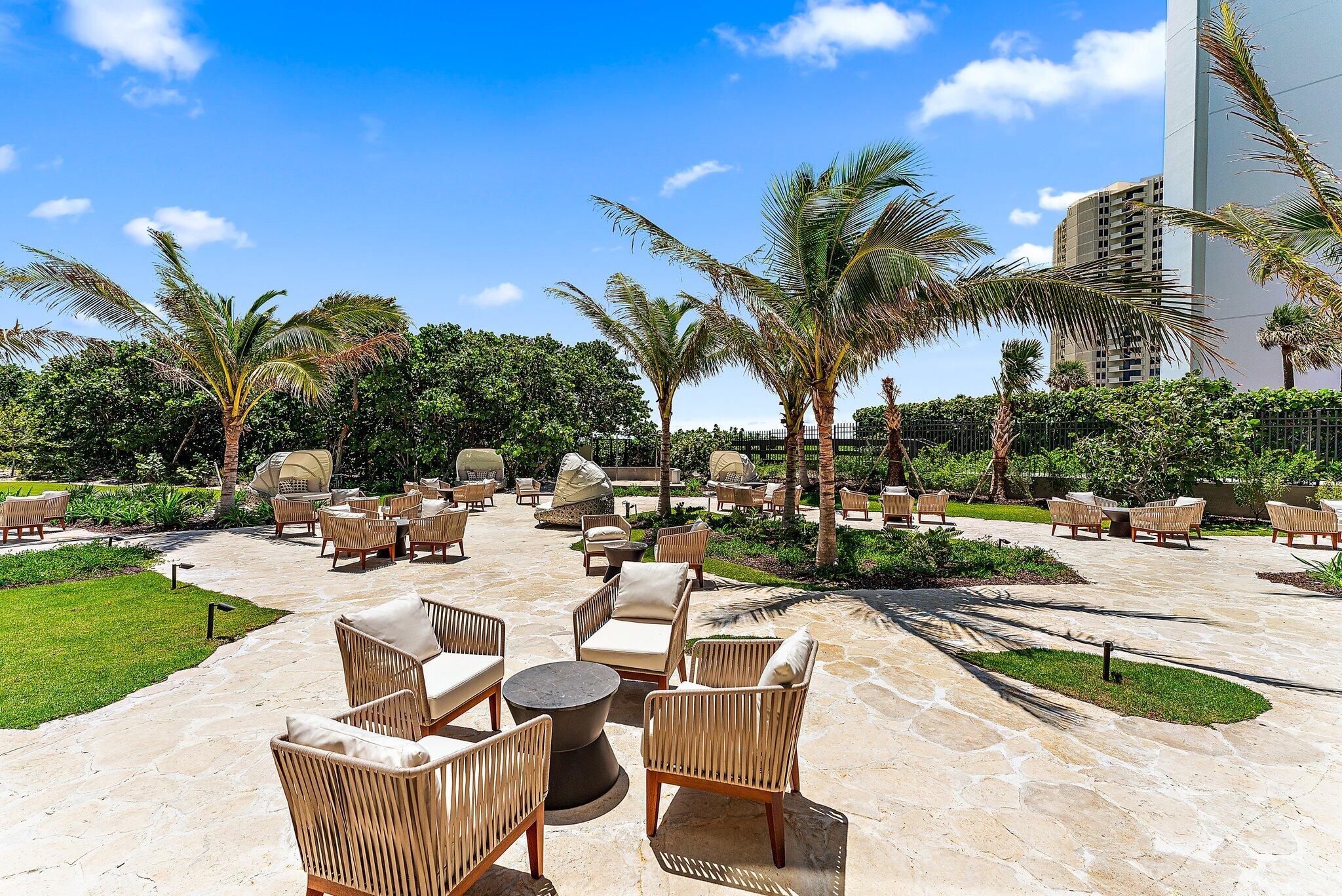3100 North Ocean Drive, Unit H1206 Singer Island, FL 33404 - Photo 55 of 78 a view of a swimming pool with outdoor seating and plants