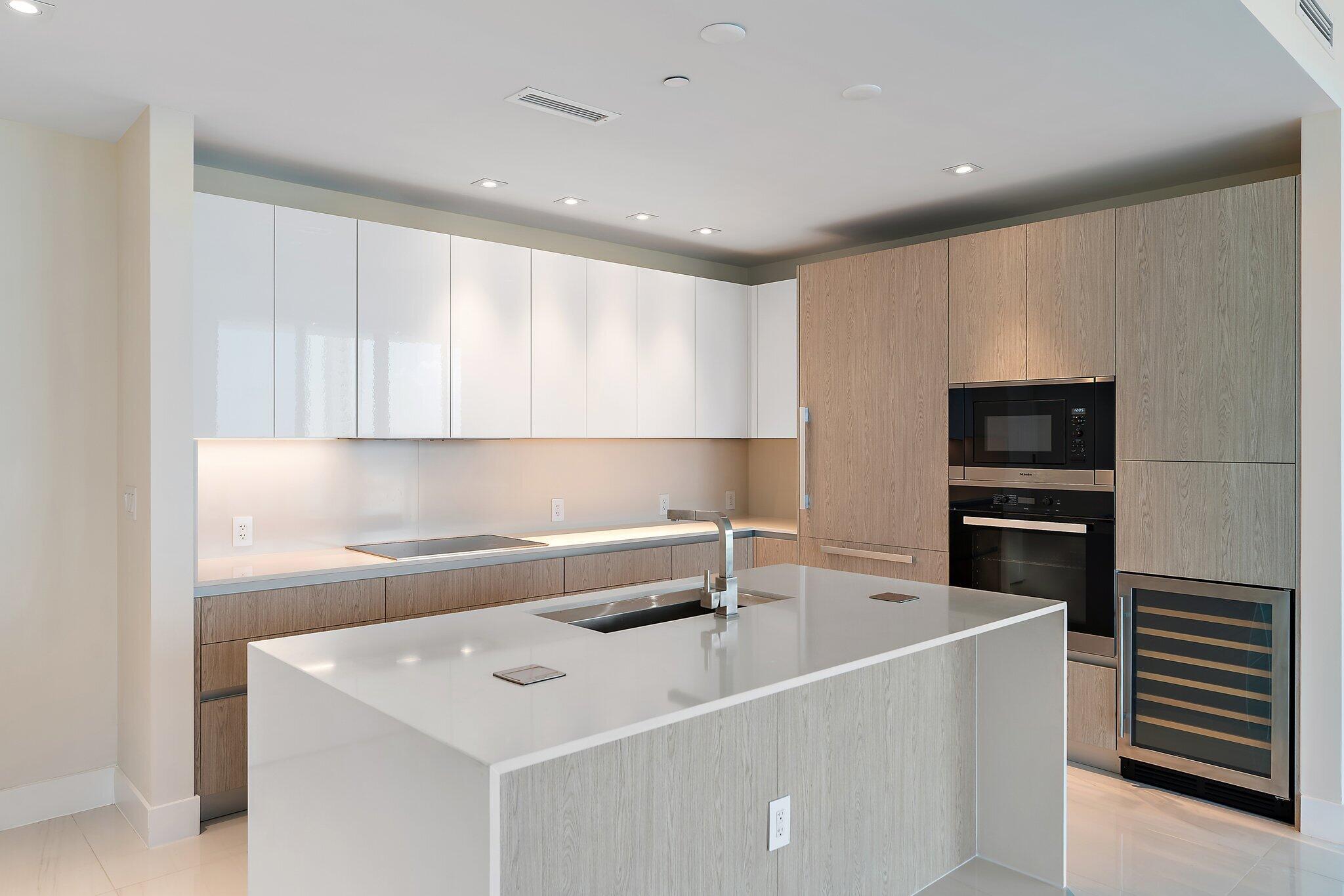 3100 North Ocean Drive, Unit H1206 Singer Island, FL 33404 - Photo 7 of 78 a kitchen with a sink stainless steel appliances and cabinets