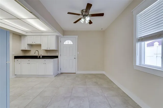 a kitchen with granite countertop a refrigerator and a sink