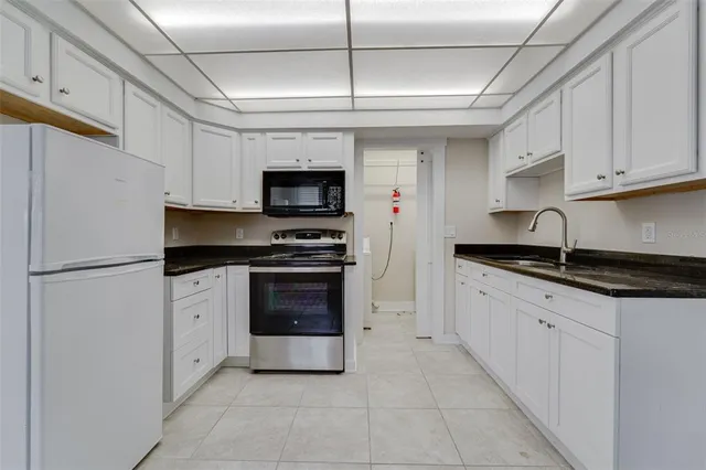 a kitchen with a refrigerator stove and microwave