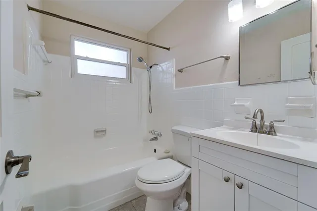 a view of a livingroom with a ceiling fan and window