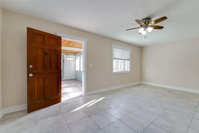 a view of a livingroom with a window and a ceiling fan