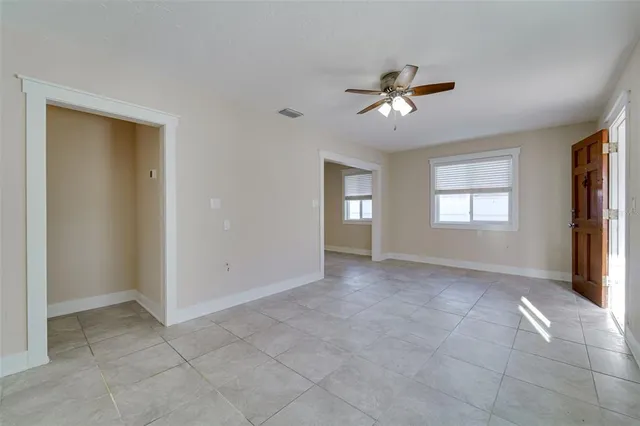 a kitchen with a refrigerator and white cabinets