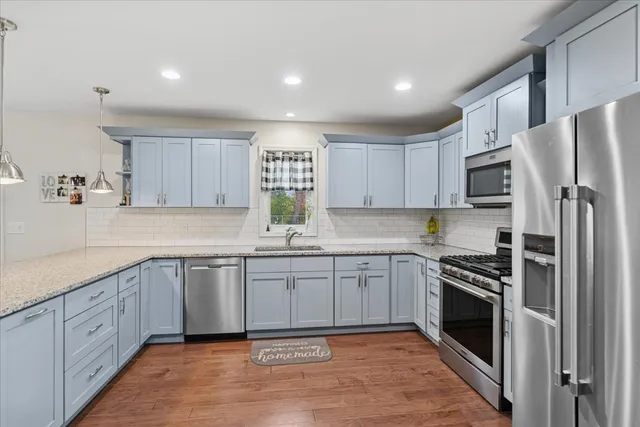 a kitchen with a sink stove and refrigerator