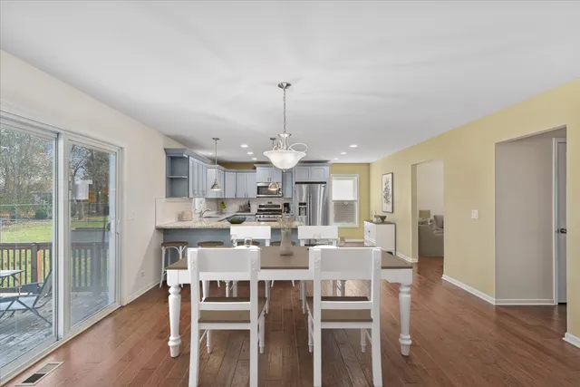 a living room with furniture and a flat screen tv with wooden floor