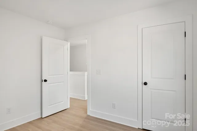 an empty room with wooden floor