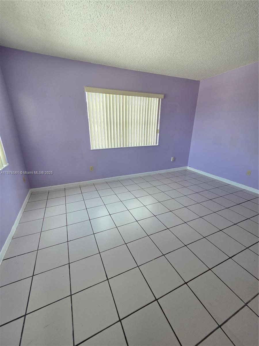 1035 West 77th Street, Unit 305 Hialeah, FL 33014 - Photo 16 of 16 a view of an empty room and window