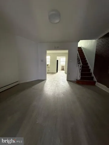 an empty room with windows and fireplace