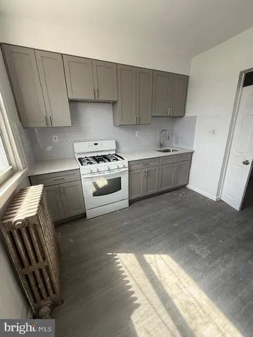 an empty room with a fireplace and windows