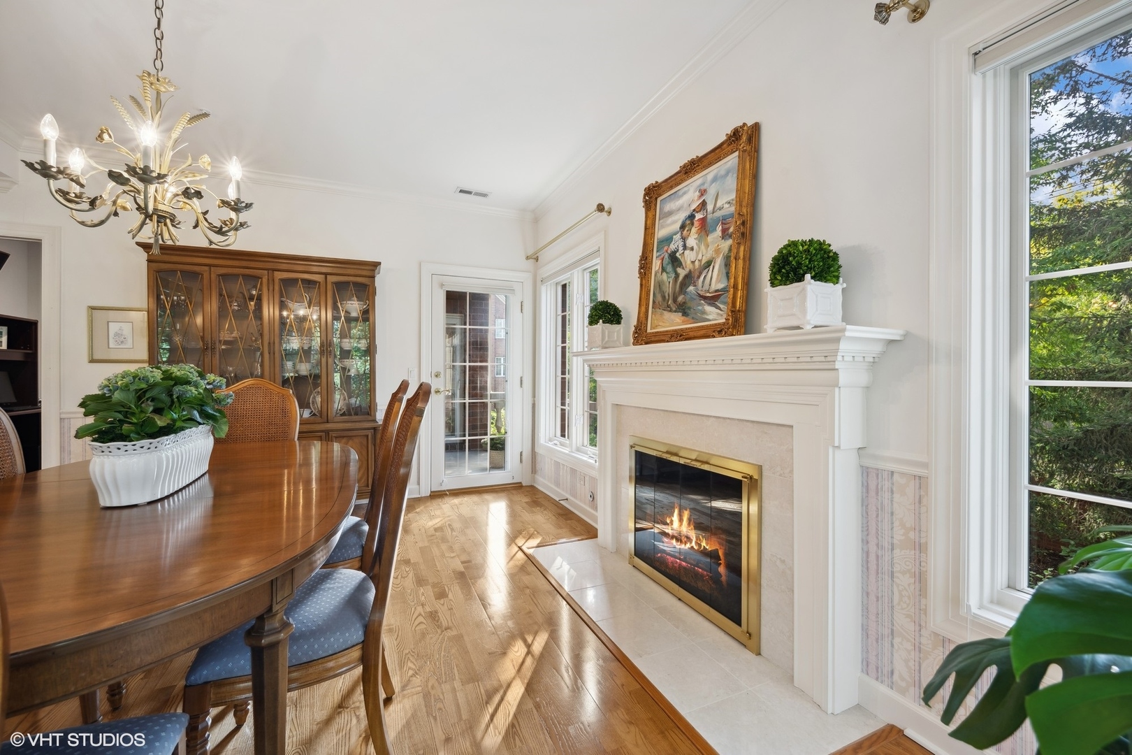 223 Regent Wood Road Northfield, IL 60093 - Photo 11 of 21 a view of a dining room with furniture a fireplace and wooden floor