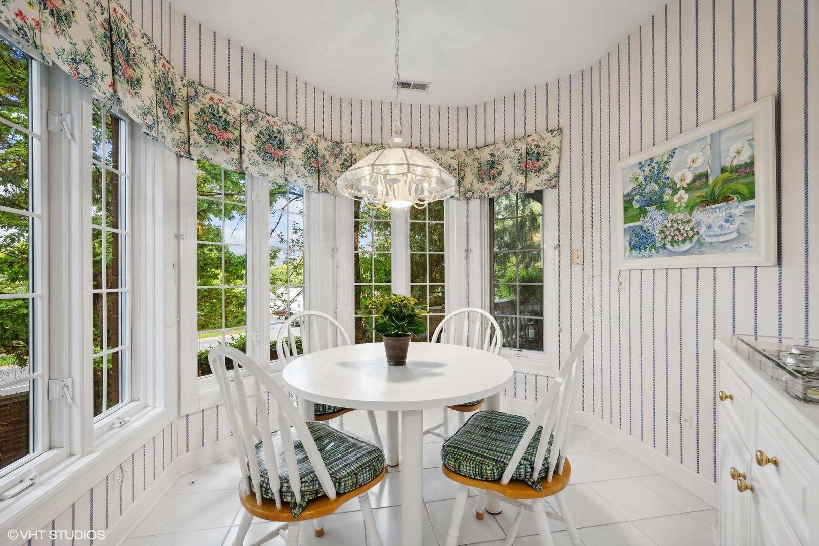 223 Regent Wood Road Northfield, IL 60093 - Photo 14 of 21 a view of a dining room with furniture a chandelier and a window