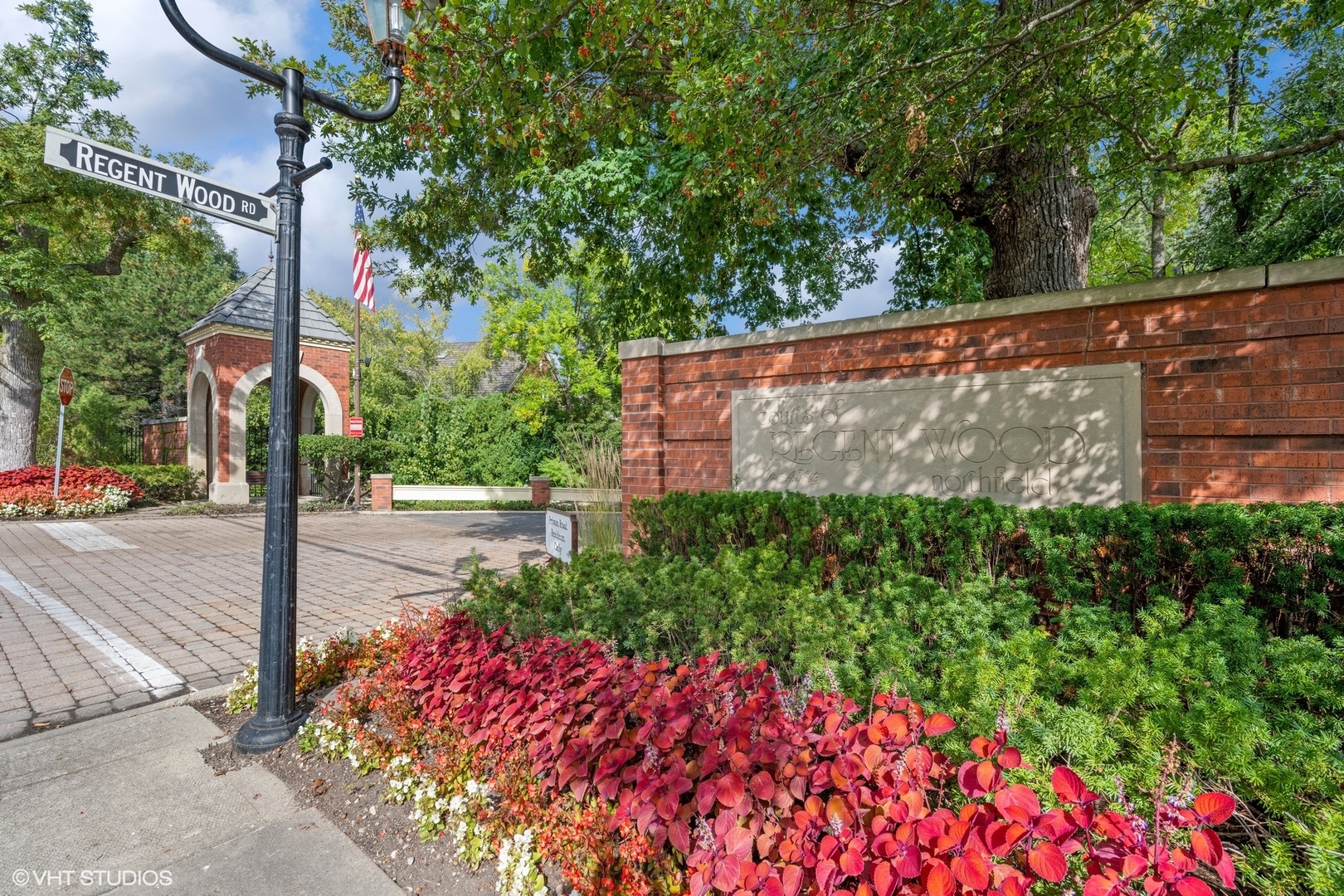 223 Regent Wood Road Northfield, IL 60093 - Photo 20 of 21 a view of a street with flower plants and tree next to a road