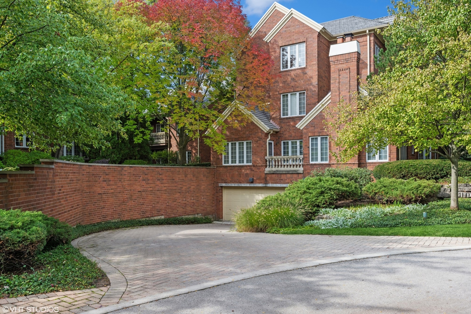 223 Regent Wood Road Northfield, IL 60093 - Photo 2 of 21 a front view of a house with a garden and plants