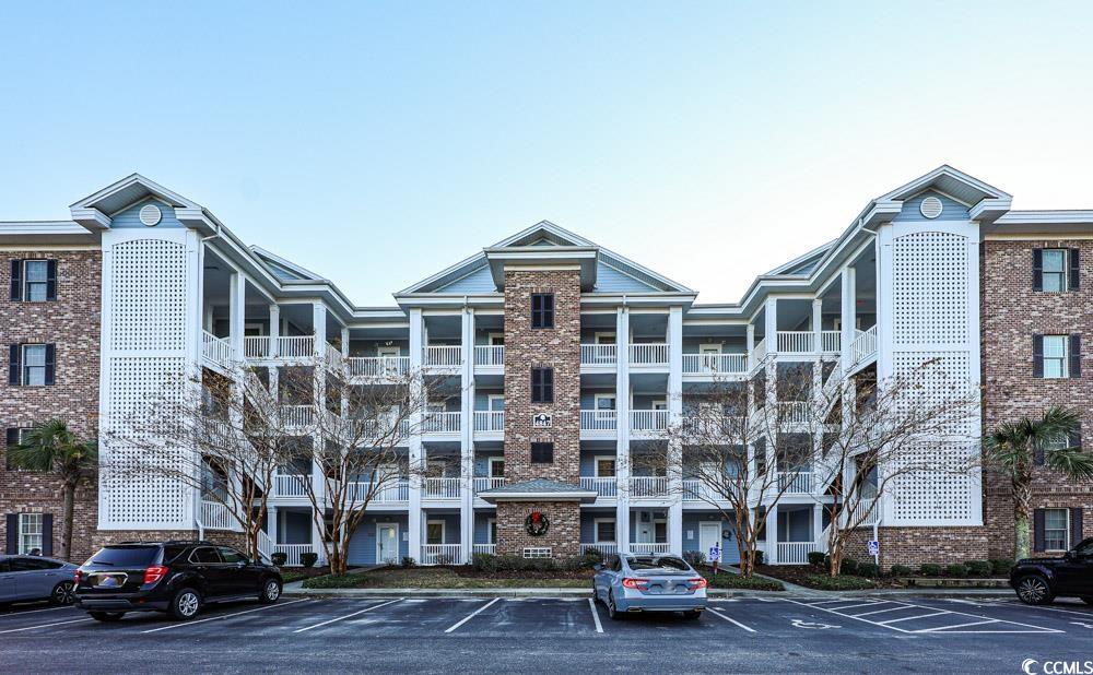 69 F Luster Leaf Circle, Unit 69F Myrtle Beach, SC 29577 - Photo 7 of 10 View of apartment building / complex with uncovered parking