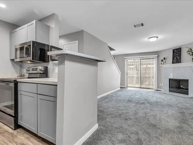 a kitchen with stainless steel appliances a refrigerator and a stove top oven