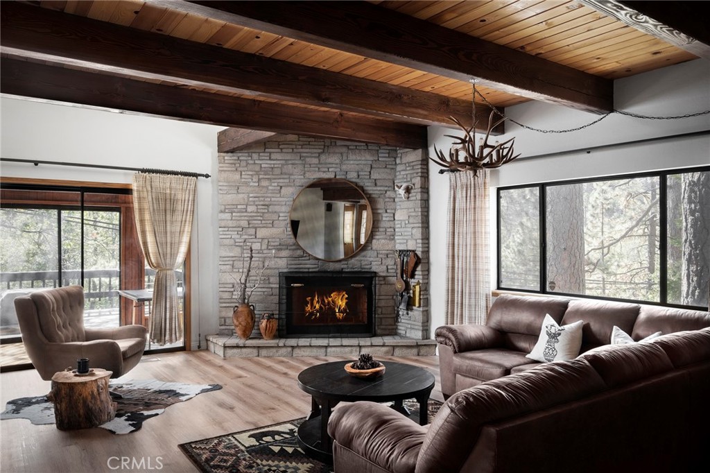 115 Golf Course Road Lake Arrowhead, CA 92352 - Photo 1 of 1 a living room with furniture a fireplace and a floor to ceiling window
