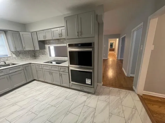 a kitchen with stainless steel appliances a stove sink and cabinets