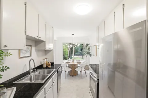 a kitchen with sink refrigerator and outdoor view