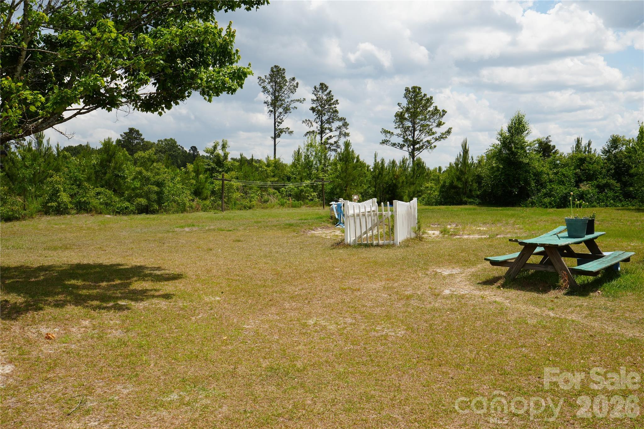 424 Press Walters Road Hartsville, SC 29550 - Photo 2 of 10 a view of a lake with a table and chairs