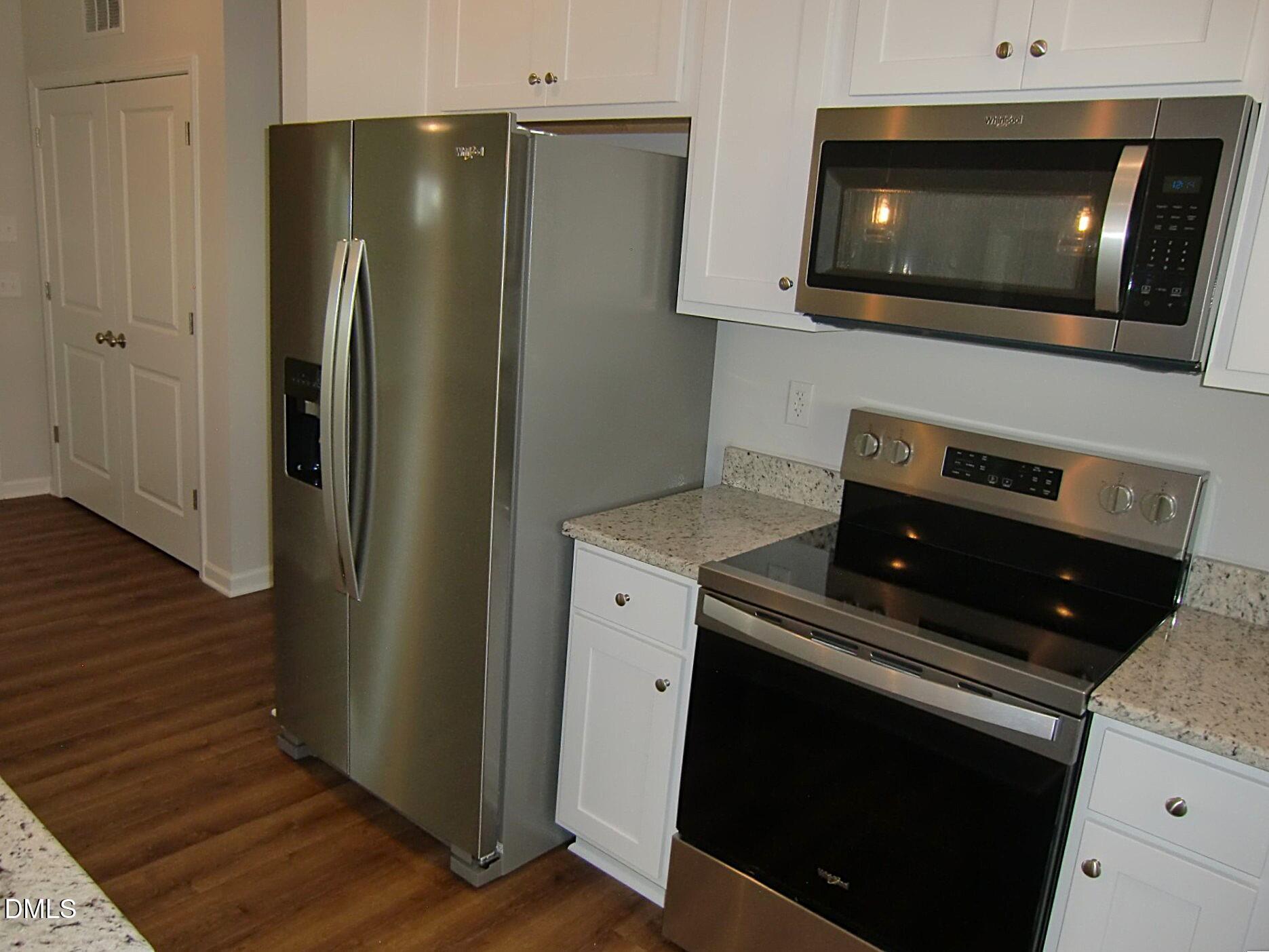 100 Covington Lane Dunn, NC 28334 - Photo 27 of 61 a kitchen with a refrigerator and cabinets