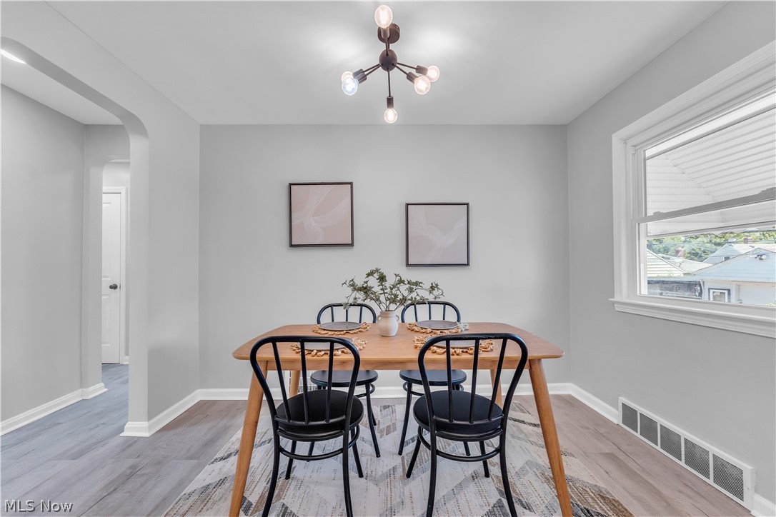 5581 Dunham Road Maple Heights, OH 44137 - Photo 11 of 33 Dining space with a notable chandelier and light hardwood / wood-style flooring