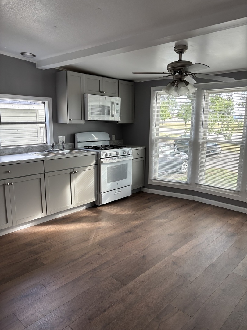 3 Franklin Drive Manteno, IL 60950 - Photo 4 of 23 a view of a kitchen with a sink dishwasher and wooden cabinets