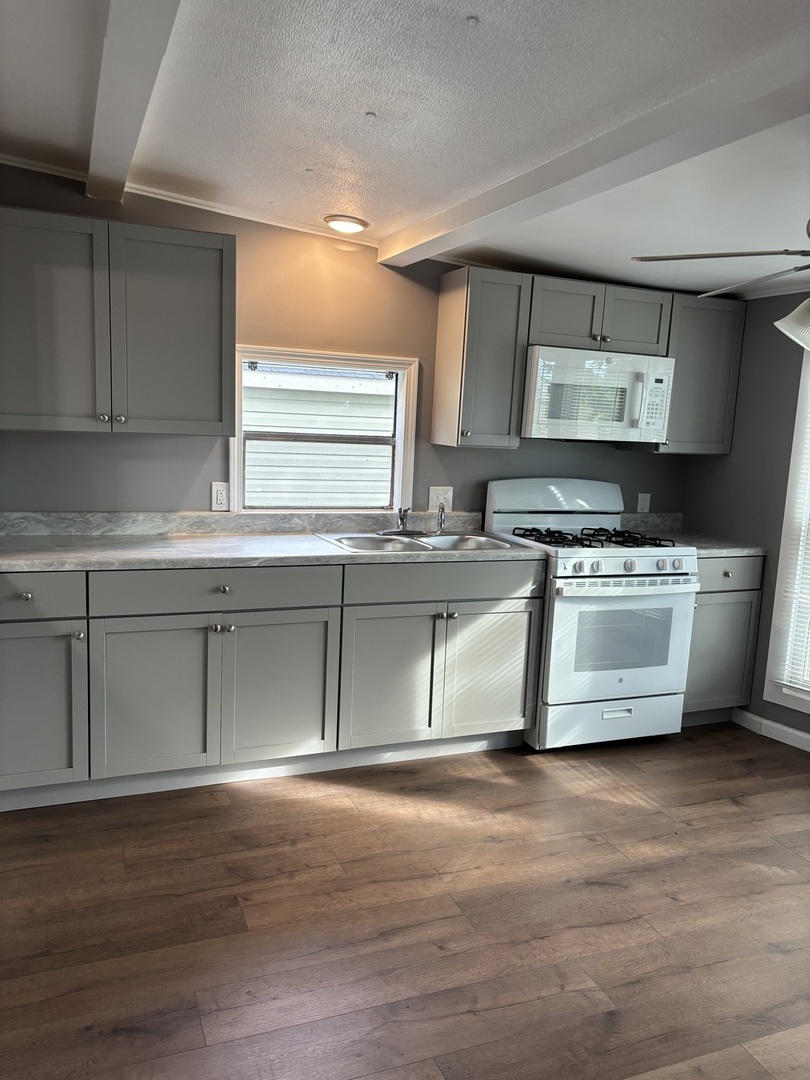 3 Franklin Drive Manteno, IL 60950 - Photo 5 of 23 a kitchen with stainless steel appliances granite countertop a sink a stove and a wooden floors