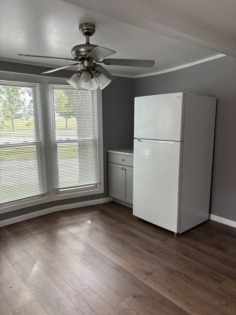 3 Franklin Drive Manteno, IL 60950 - Photo 6 of 23 a view of a livingroom with a ceiling fan window and wooden floor