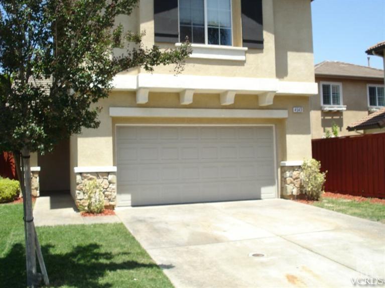 4543 Rivergate Court Riverside, CA 92505 - Photo 2 of 10 a front view of a house with a yard and garage