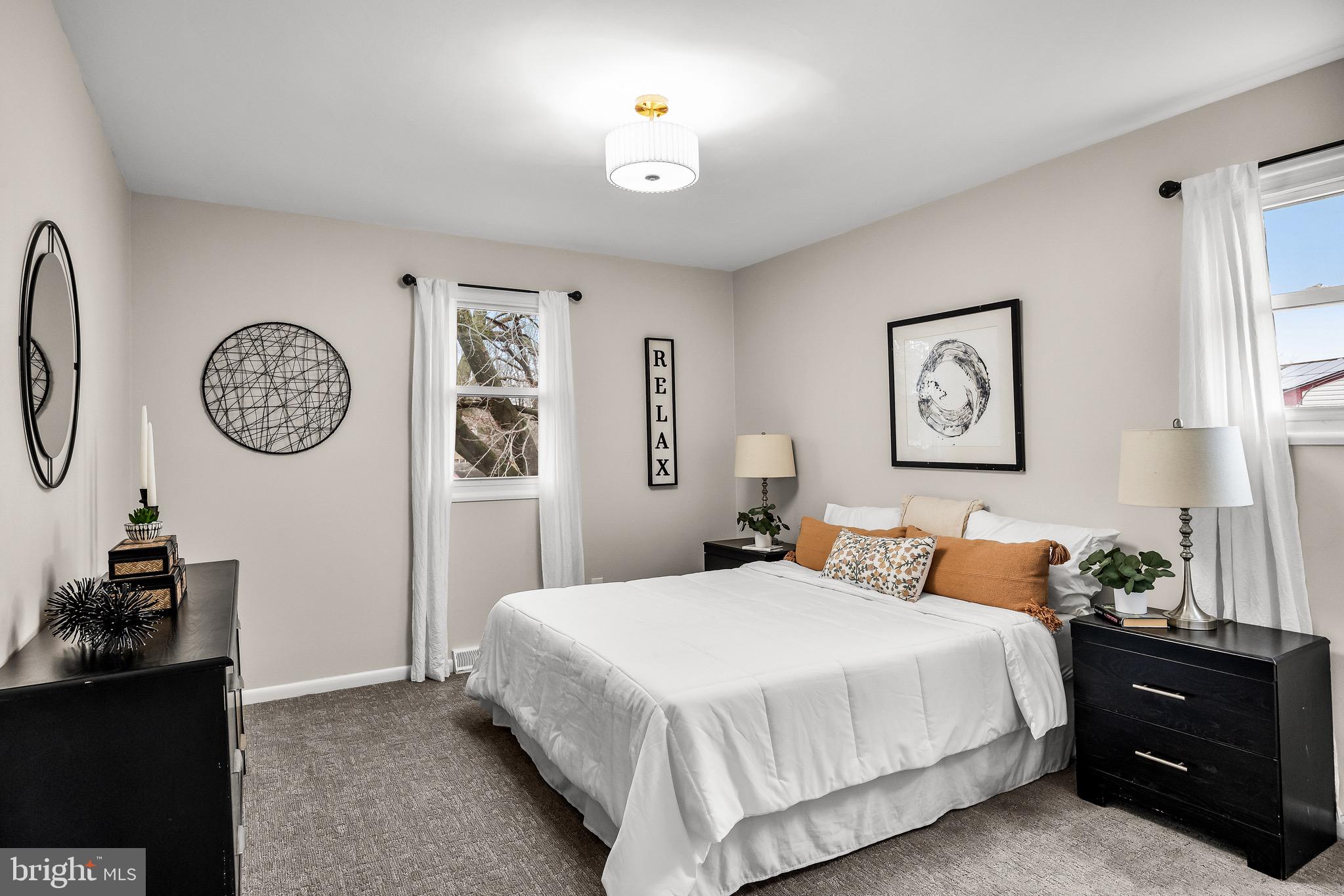 301 Cardinal Road Beverly, NJ 08010 - Photo 14 of 27 a bedroom with a bed and a lamp on dresser