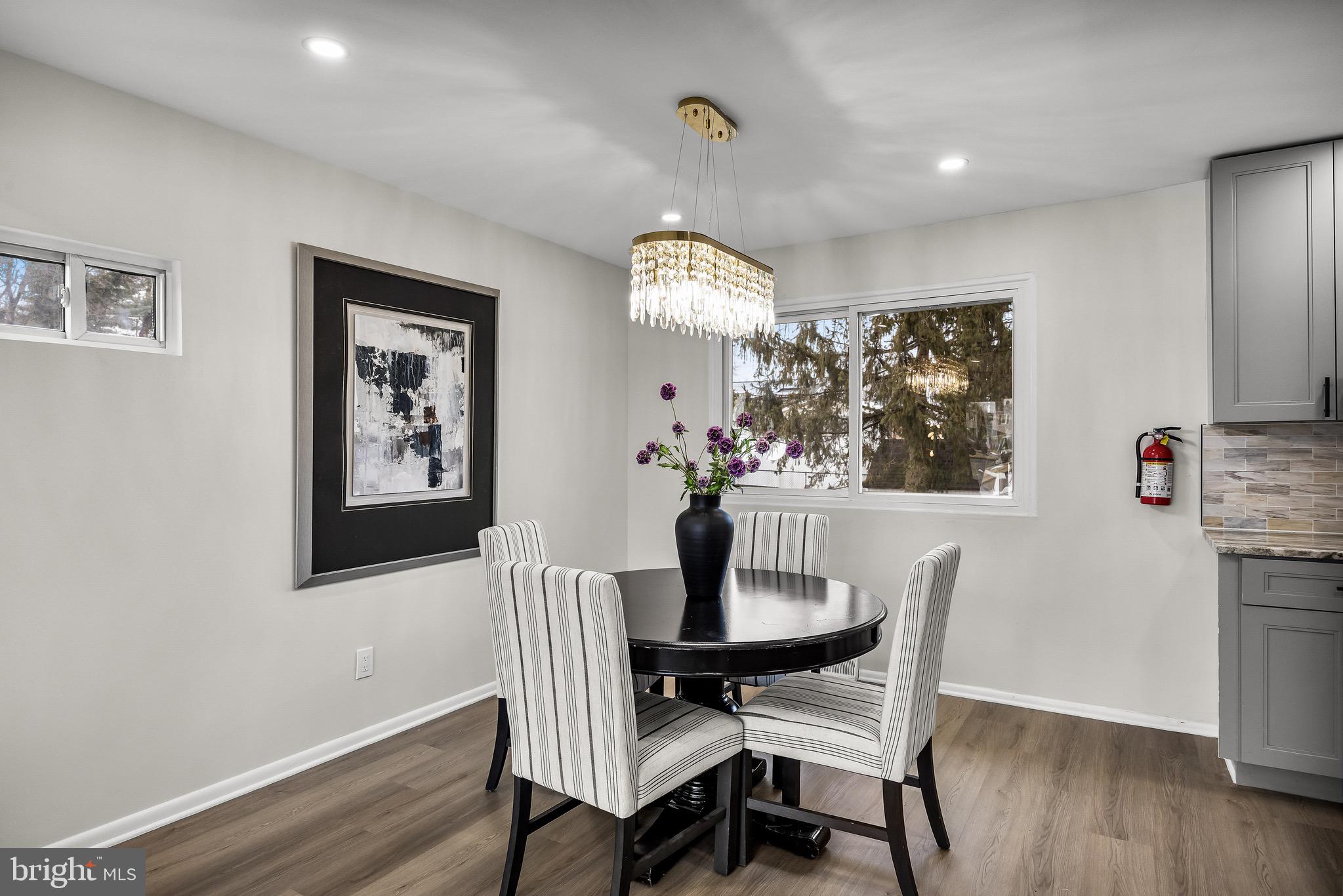 301 Cardinal Road Beverly, NJ 08010 - Photo 9 of 27 a view of a dining room with furniture wooden floor and chandelier