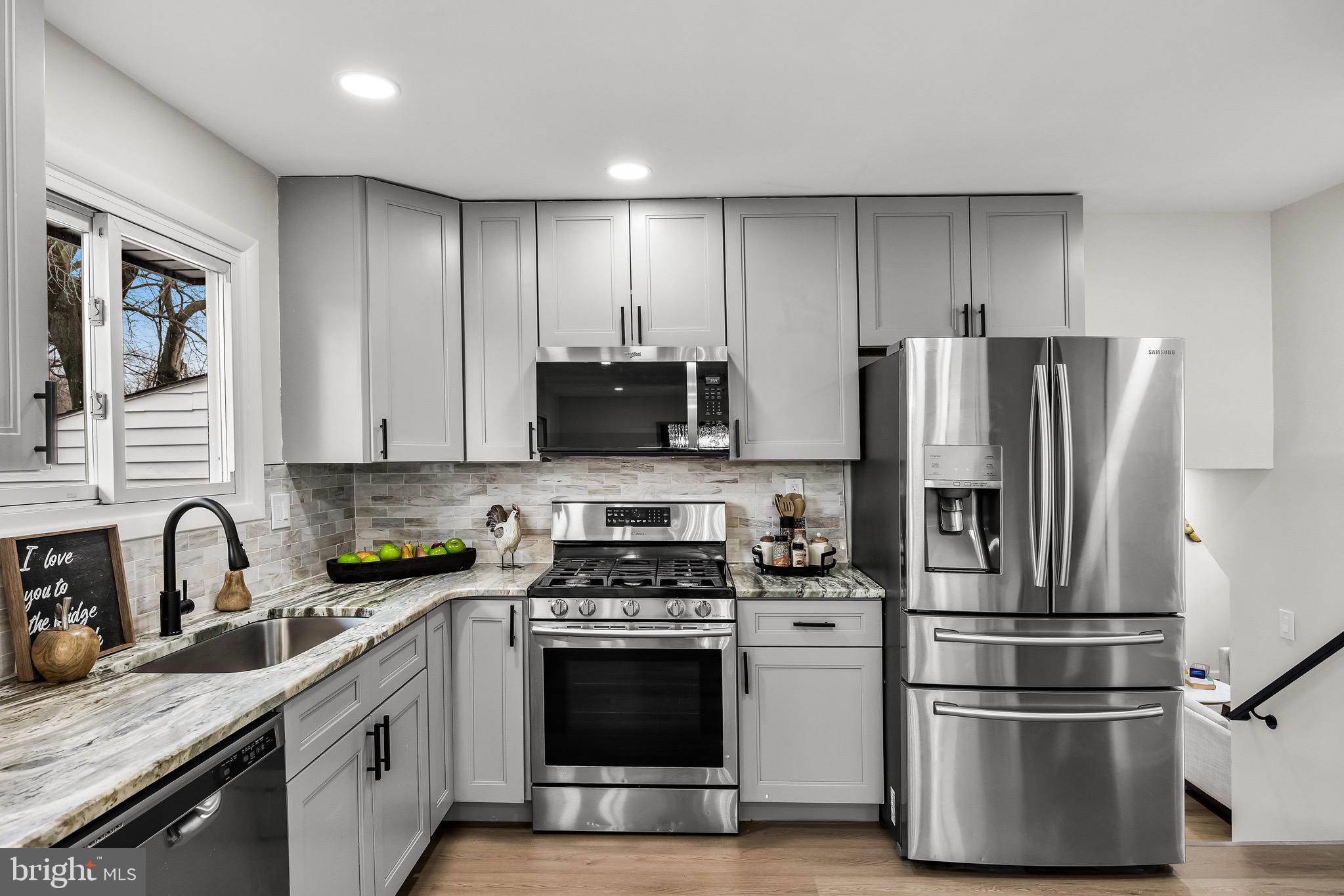301 Cardinal Road Beverly, NJ 08010 - Photo 10 of 27 a kitchen with stainless steel appliances granite countertop a refrigerator stove and sink
