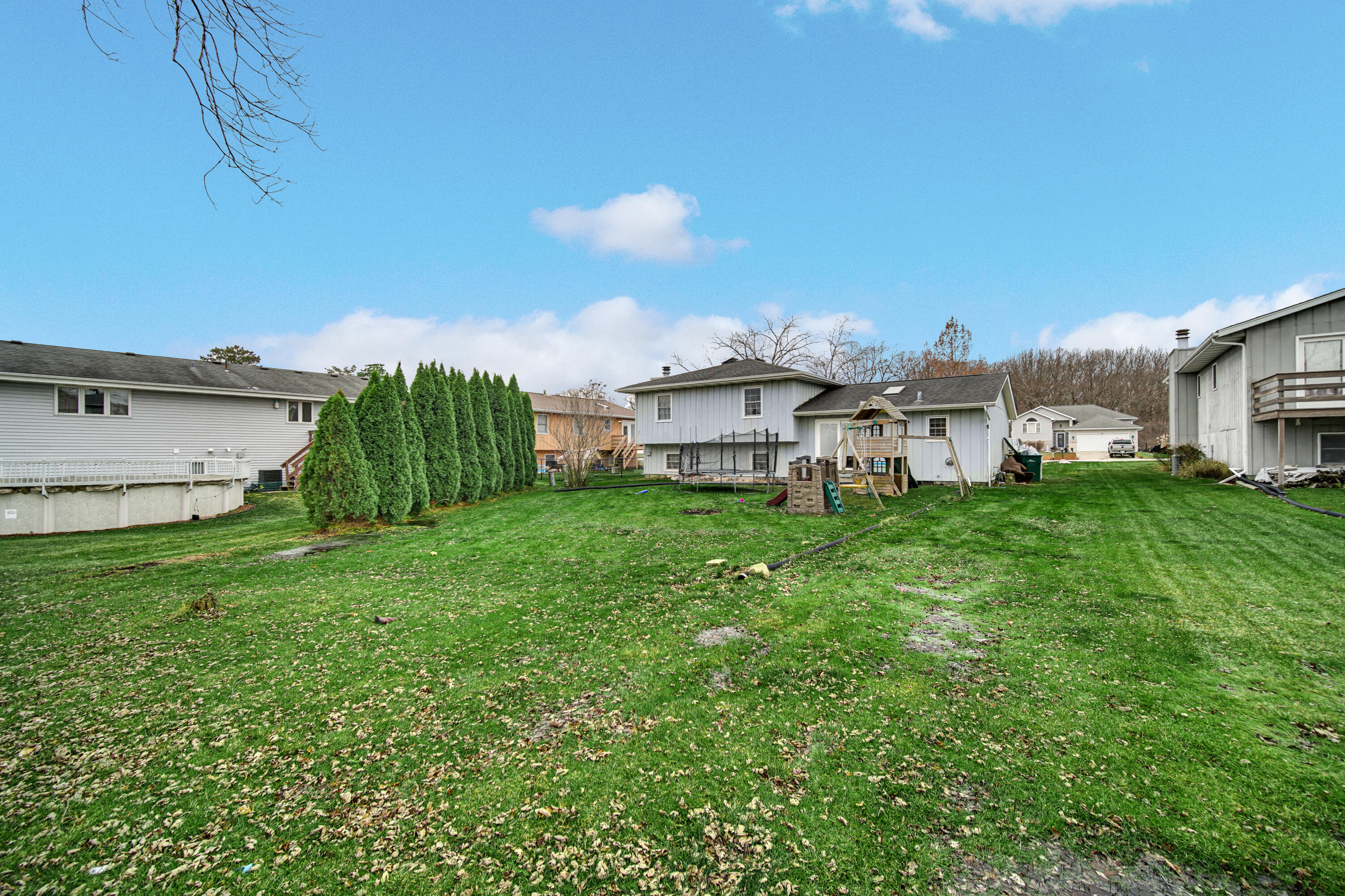4038 Kingsway Drive Crown Point, IN 46307 - Photo 18 of 18 a view of a house with a yard and sitting area