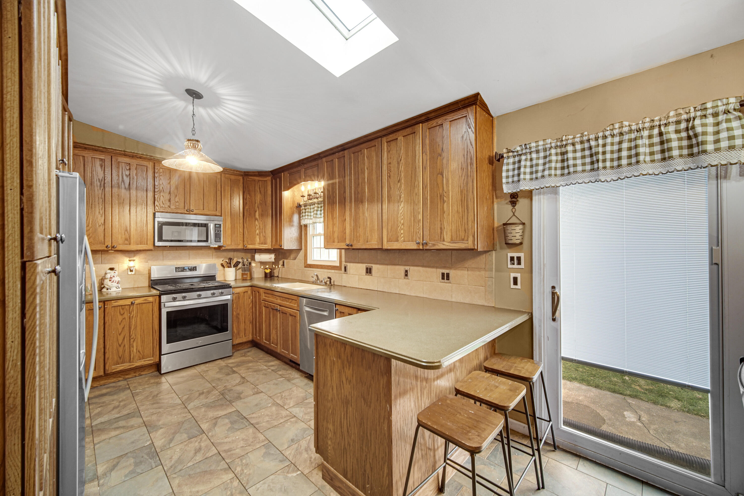4038 Kingsway Drive Crown Point, IN 46307 - Photo 5 of 18 a kitchen with a stove a sink and a refrigerator
