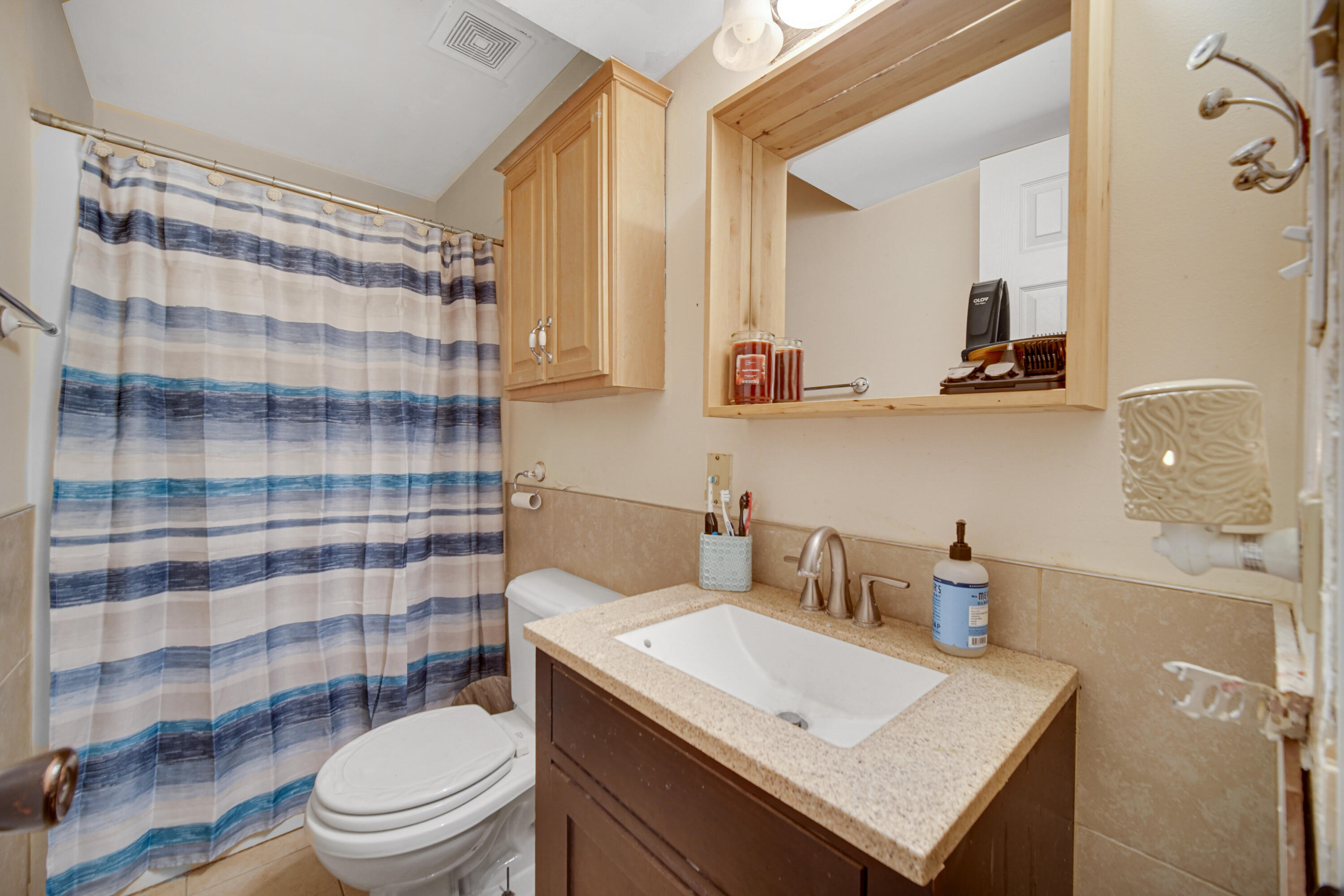 4038 Kingsway Drive Crown Point, IN 46307 - Photo 10 of 18 a bathroom with a sink a toilet a shower and a mirror