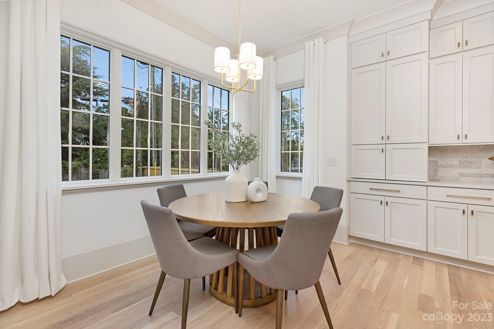 1213 Reece Road Charlotte, NC 28209 - Photo 15 of 31 a view of a dining room with furniture and chandelier