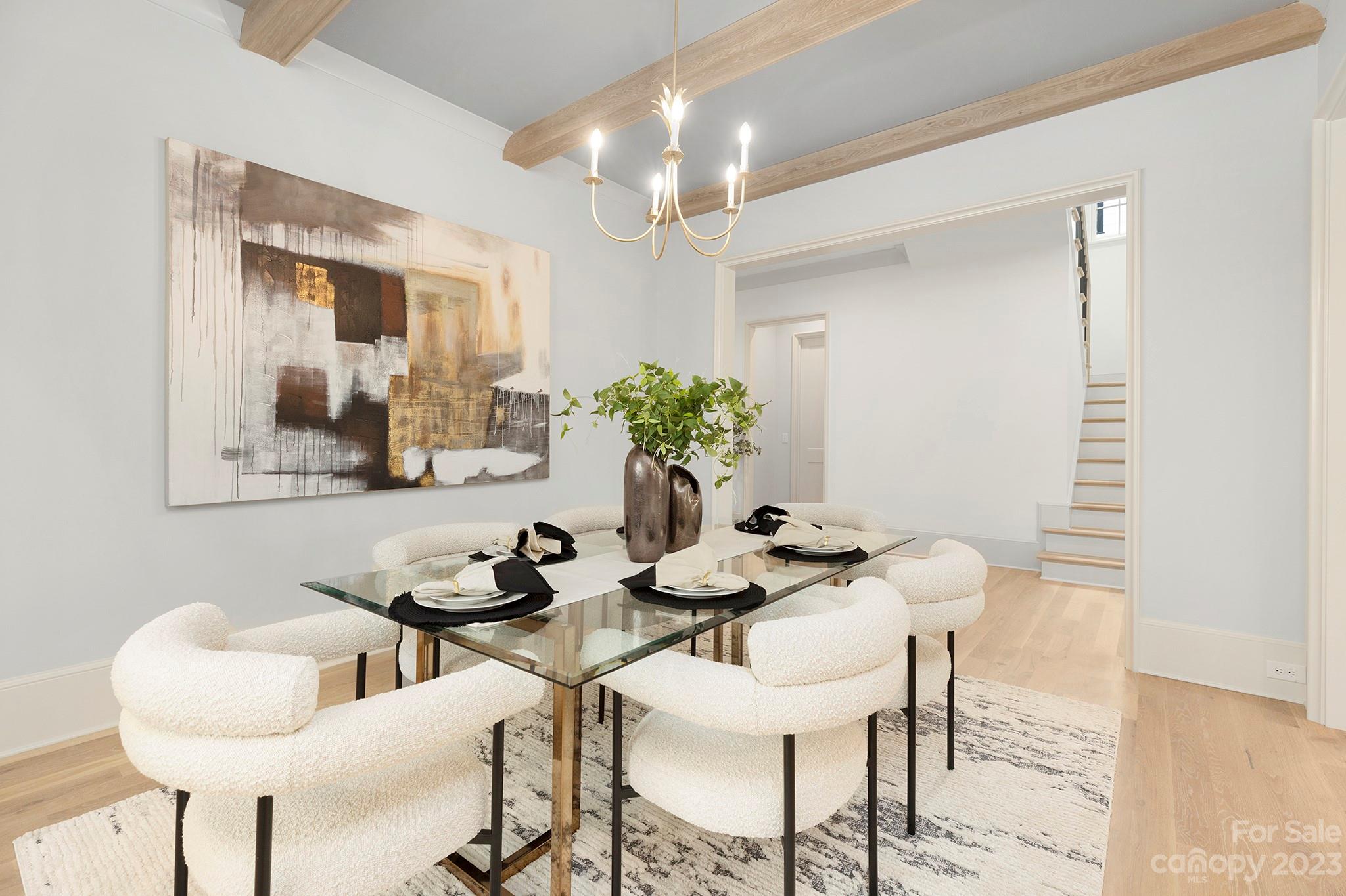 1213 Reece Road Charlotte, NC 28209 - Photo 19 of 31 a dining room with furniture and chandelier