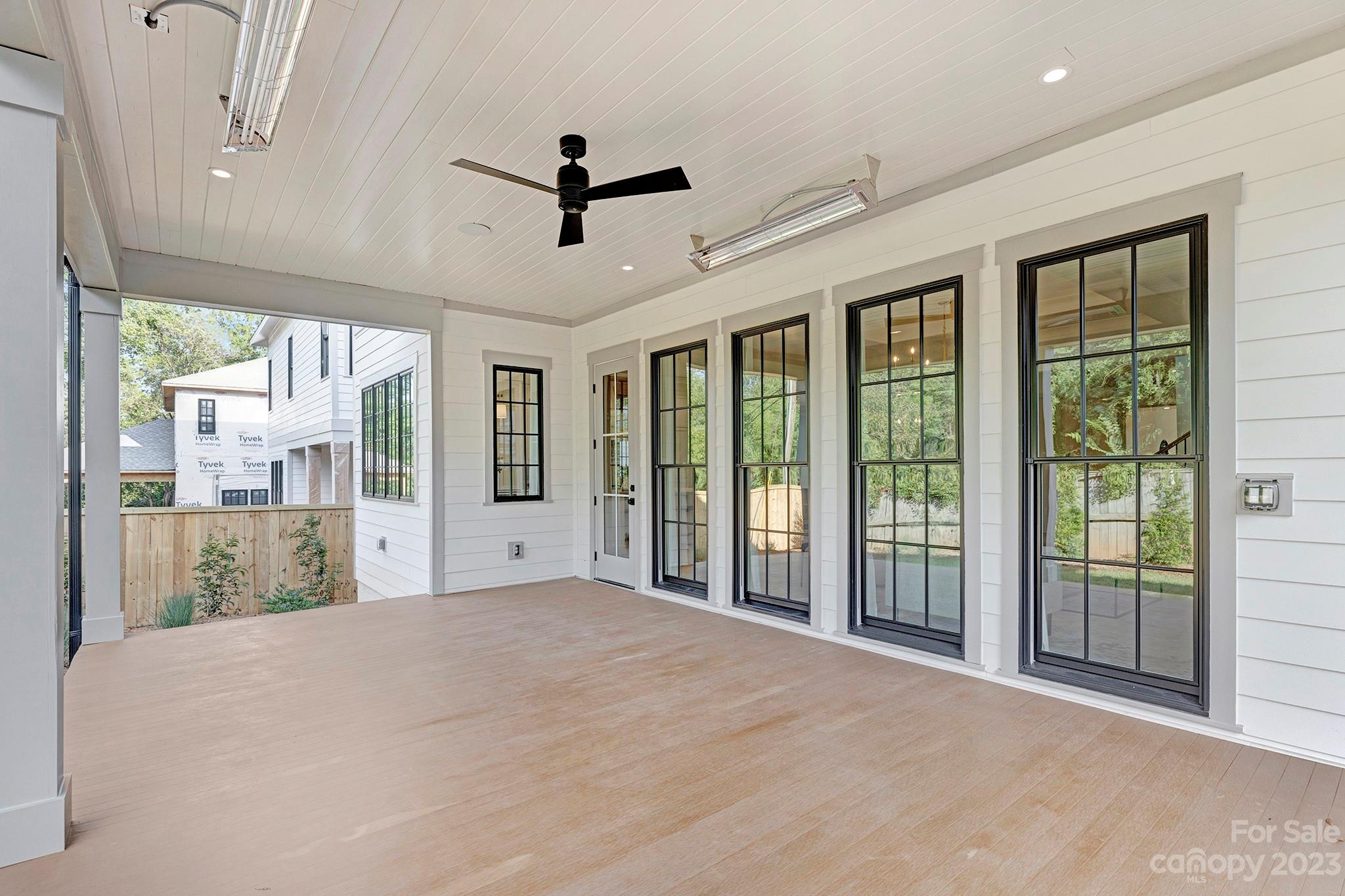 1213 Reece Road Charlotte, NC 28209 - Photo 30 of 31 a view of a livingroom with wooden floor and a ceiling fan