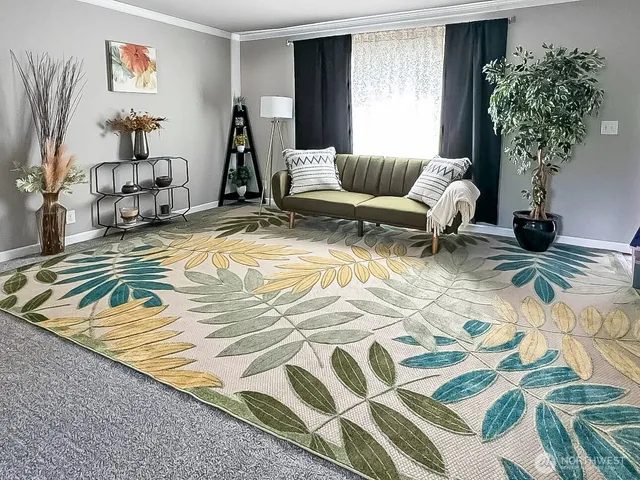 a living room with furniture and a potted plant