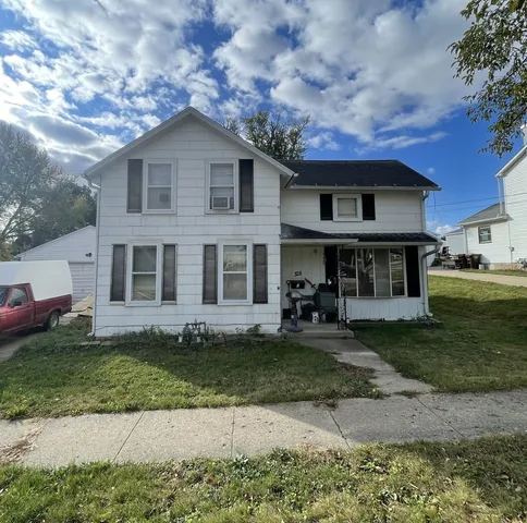 a view of a house with a yard and sitting area