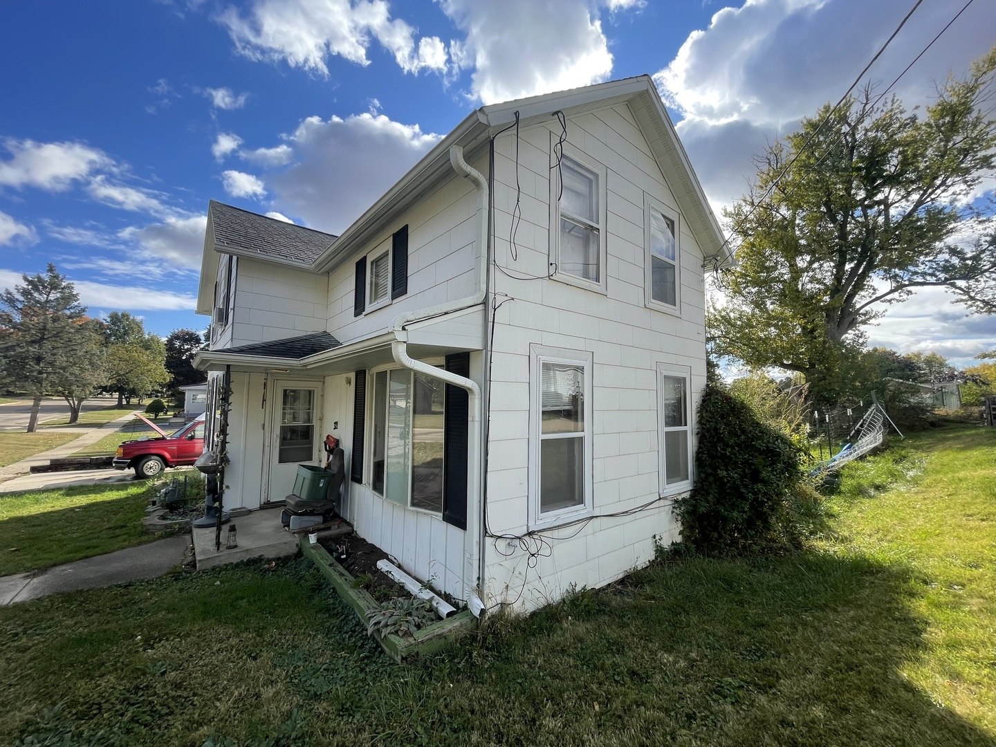 328 West Locust Street Lanark, IL 61046 - Photo 4 of 5 a view of a white house with a yard and a garden