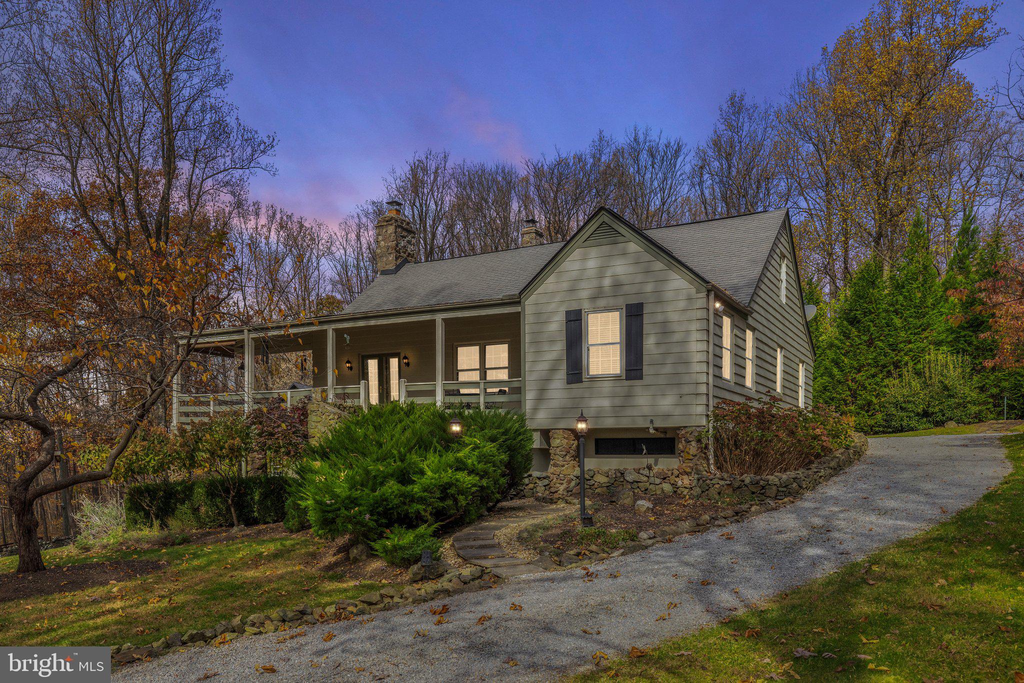 17970 Raven Rocks Road Bluemont, VA 20135 - Photo 3 of 78 a front view of a house with a yard and trees