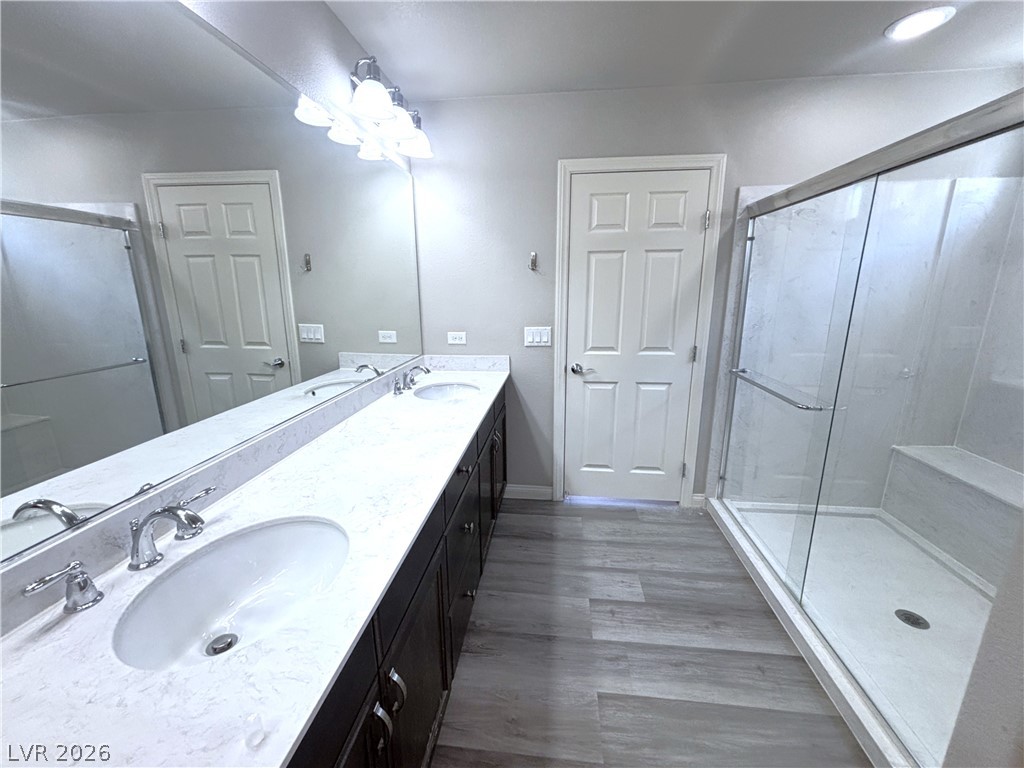 6425 Jackson Spring Road Las Vegas, NV 89118 - Photo 26 of 31 Double vanity sinks and a glass-enclosed shower create a practical bathroom retreat.