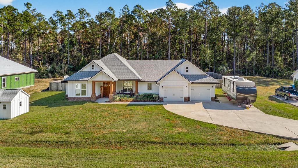 75774 Edwards Road Yulee, FL 32097 - Photo 2 of 70 a front view of a house with garden