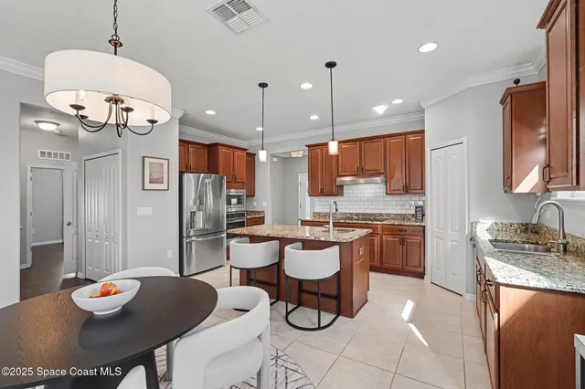 a large kitchen with a table and chairs