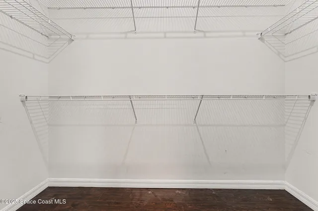 a bathroom with a granite countertop bathtub sink vanity mirror and toilet