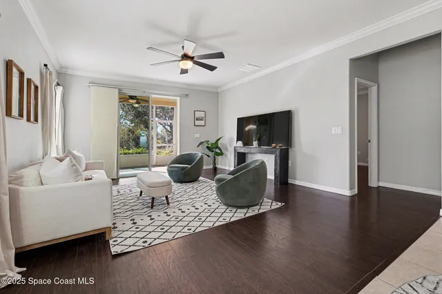 a living room with furniture wooden floor and a flat screen tv