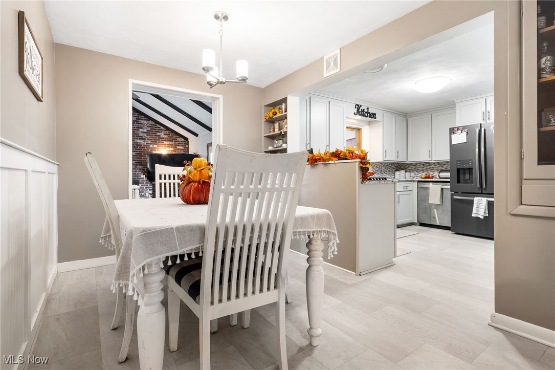 4727 15th Street Northwest Canton, OH 44708 - Photo 12 of 37 Dining room featuring a chandelier and baseboards
